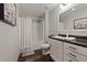 Bathroom featuring a vanity with dark countertop, a framed mirror, and a shower with a curtain at 21375 Nw 150Th Avenue Rd, Micanopy, FL 32667