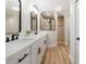 Bright bathroom featuring double vanity with black hardware, and a walk-in shower with archway entry at 21375 Nw 150Th Avenue Rd, Micanopy, FL 32667