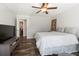 Bedroom with a large bed, ceiling fan, wood-look floors and closet with organizers at 21375 Nw 150Th Avenue Rd, Micanopy, FL 32667
