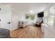 Bright bedroom with hardwood-style floors, overhead lighting, crib and view of the backyard at 21375 Nw 150Th Avenue Rd, Micanopy, FL 32667
