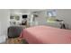 Brightly lit bedroom features hardwood-style flooring, large windows, television and crib in background at 21375 Nw 150Th Avenue Rd, Micanopy, FL 32667