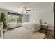 Bright bedroom featuring white walls, large windows, and a comfortable white armchair at 21375 Nw 150Th Avenue Rd, Micanopy, FL 32667