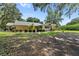 Charming ranch-style home with manicured landscaping, a covered patio, and ample parking in a tranquil setting at 21375 Nw 150Th Avenue Rd, Micanopy, FL 32667