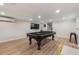Basement game room featuring a pool table, entertainment system, and light wood-look floors at 21375 Nw 150Th Avenue Rd, Micanopy, FL 32667