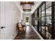 Bright entryway boasting hardwood floors, a decorative ceiling, stylish furniture, and a large window at 21375 Nw 150Th Avenue Rd, Micanopy, FL 32667