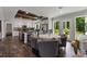Modern kitchen featuring stainless steel appliances, a large island, and an adjacent dining area with natural light at 21375 Nw 150Th Avenue Rd, Micanopy, FL 32667