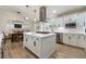 Modern kitchen with white cabinets, stainless steel appliances, and a center island with a gas cooktop at 21375 Nw 150Th Avenue Rd, Micanopy, FL 32667