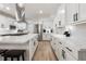 Bright, updated kitchen with white cabinets, stainless steel appliances, and an island with seating at 21375 Nw 150Th Avenue Rd, Micanopy, FL 32667