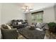 Cozy living room area with a comfortable leather sofa, accent chair, and a plush rug at 21375 Nw 150Th Avenue Rd, Micanopy, FL 32667