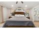 Main bedroom featuring natural light, wood floors, and a view into the on-suite bathroom at 21375 Nw 150Th Avenue Rd, Micanopy, FL 32667
