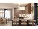 Modern kitchen featuring a marble countertop island with bar stools and pendant lighting at 2360 Ocean Shore Blvd # 1, Ormond Beach, FL 32176