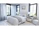Bright bedroom with large windows, white bedding, and neutral decor, creating a serene atmosphere at 2360 Ocean Shore Blvd # 2, Ormond Beach, FL 32176