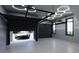 Modern garage featuring a black door, epoxy floor, and contemporary lighting at 2360 Ocean Shore Blvd # 2, Ormond Beach, FL 32176