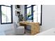 Bright home office with a unique burl wood desk, stylish chair, and natural light at 2360 Ocean Shore Blvd # 2, Ormond Beach, FL 32176