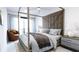 Serene bedroom with a four-poster bed, tufted headboard, and soft, natural light at 2360 Ocean Shore Blvd # 2, Ormond Beach, FL 32176
