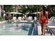 Inviting pool area with lounge chairs, palm trees, and a relaxed atmosphere for residents to enjoy at 2360 Ocean Shore Blvd # 2, Ormond Beach, FL 32176
