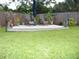 Spacious backyard with a raised deck, lawn and lush greenery, ideal for outdoor living at 39 Benjamin Dr, Ormond Beach, FL 32176
