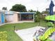 Spacious backyard with a wooden deck, seating, and covered patio, perfect for outdoor enjoyment at 39 Benjamin Dr, Ormond Beach, FL 32176
