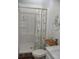 Compact bathroom featuring a shower and decorated with an anchor-themed mirror and floral-themed shower curtain at 39 Benjamin Dr, Ormond Beach, FL 32176