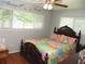 Comfortable bedroom featuring a dark wood bed frame, wood floors, and abundant natural light at 39 Benjamin Dr, Ormond Beach, FL 32176