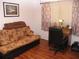Functional bedroom or office space with a futon sofa, desk area, and wood-look flooring at 39 Benjamin Dr, Ormond Beach, FL 32176
