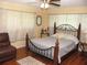 Comfortable bedroom with a ceiling fan, wood floors, and soft, filtered natural light at 39 Benjamin Dr, Ormond Beach, FL 32176