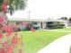Charming single-story home with a well-manicured lawn and colorful landscaping, offering great curb appeal at 39 Benjamin Dr, Ormond Beach, FL 32176