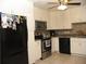 Well-lit kitchen with white cabinets, stainless steel appliances, and tiled backsplash at 39 Benjamin Dr, Ormond Beach, FL 32176