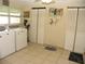 Functional laundry room with modern washer and dryer, storage and ample space at 39 Benjamin Dr, Ormond Beach, FL 32176