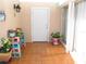 Enclosed patio area with tiled flooring and colorful plants in decorative pots at 39 Benjamin Dr, Ormond Beach, FL 32176