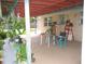 Covered patio with seating, plants, and room to relax and entertain outdoors at 39 Benjamin Dr, Ormond Beach, FL 32176