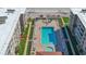 Aerial view of the building showcasing the large rectangular community pool and surrounding deck area at 4155 S Atlantic Ave # 204, New Smyrna Beach, FL 32169