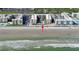 Coastal aerial view of condo buildings on the beach with manicured lawns and a refreshing pool at 4155 S Atlantic Ave # 204, New Smyrna Beach, FL 32169