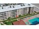 Aerial view of the condo featuring multiple stories with private balconies and a community pool at 4155 S Atlantic Ave # 204, New Smyrna Beach, FL 32169