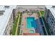 Aerial view of the building showcasing the large rectangular community pool and surrounding deck area at 4155 S Atlantic Ave # 204, New Smyrna Beach, FL 32169