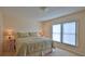 Comfortable bedroom with a queen-size bed and natural light at 4155 S Atlantic Ave # 204, New Smyrna Beach, FL 32169