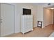 Bedroom featuring a TV, closet and easy access to the hallway at 4155 S Atlantic Ave # 204, New Smyrna Beach, FL 32169