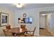 Dining area with a round wood table and wicker chairs at 4155 S Atlantic Ave # 204, New Smyrna Beach, FL 32169