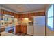 Bright kitchen with essential appliances and wooden cabinets, creating a practical cooking space at 4155 S Atlantic Ave # 204, New Smyrna Beach, FL 32169