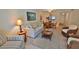 Comfortable living room with a casual dining area, featuring wicker furniture and beach accents at 4155 S Atlantic Ave # 204, New Smyrna Beach, FL 32169