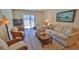 Cozy living room with comfortable seating, sliding glass doors, and beach-inspired decor at 4155 S Atlantic Ave # 204, New Smyrna Beach, FL 32169