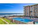Inviting pool and sun deck with ocean view, offering relaxation and leisure by the beach at 4155 S Atlantic Ave # 204, New Smyrna Beach, FL 32169