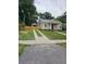 Charming single-story home featuring a welcoming front porch and a well-maintained lawn at 441 N Kentucky Ave, Deland, FL 32724