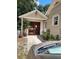 A detached garage has double doors and is connected to the main house by a portico and sidewalk at 441 N Kentucky Ave, Deland, FL 32724