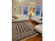 Cozy living room with hardwood floors, bright windows, and stylish furniture at 441 N Kentucky Ave, Deland, FL 32724