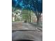 Driving down a tree-lined street near red brick buildings; mature trees overhead at 441 N Kentucky Ave, Deland, FL 32724