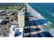 An aerial daytime view of a condo on the beach overlooking the ocean with a pool area between the building and ocean at 89 S Atlantic Ave # 1004, Ormond Beach, FL 32176