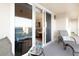 Balcony with view into living area and featuring ocean views, tiled floors and lounge seating at 89 S Atlantic Ave # 1004, Ormond Beach, FL 32176