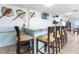 View of a bar area with seating, tv, and ocean-themed decorations at 89 S Atlantic Ave # 1004, Ormond Beach, FL 32176