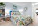 Bedroom with light blue walls, adjacent to a door and decorated with modern mirror at 89 S Atlantic Ave # 1004, Ormond Beach, FL 32176